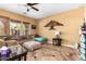 Comfortable living room with neutral tones, tiled floors, and ample natural light streaming in from large windows at 20620 W Walton Dr, Buckeye, AZ 85396