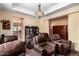 Spacious living room features reclining leather seating and an elegant hanging light fixture at 20620 W Walton Dr, Buckeye, AZ 85396