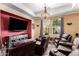 Spacious living room featuring multiple recliners, a TV, and a decorative chandelier at 20620 W Walton Dr, Buckeye, AZ 85396