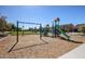 Swings and playset in the community playground at 20620 W Walton Dr, Buckeye, AZ 85396