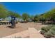 A park area featuring a playground with swings, a slide, and play equipment in a landscaped environment at 20620 W Walton Dr, Buckeye, AZ 85396