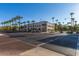 View of a commercial building situated on the corner of a street, lined with lush palm trees at 20620 W Walton Dr, Buckeye, AZ 85396