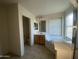 Bathroom featuring a corner soaking tub and a vanity with a sink and mirror at 2113 E Sunland Ave, Phoenix, AZ 85040