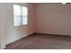 Carpeted bedroom with bright, natural light from a large window at 2113 E Sunland Ave, Phoenix, AZ 85040