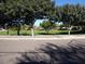 Lush community park surrounded by mature trees with sidewalks on a bright sunny day at 2113 E Sunland Ave, Phoenix, AZ 85040