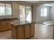 Bright kitchen featuring a center island, granite counters, and an open layout to the dining area at 2113 E Sunland Ave, Phoenix, AZ 85040