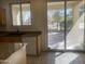 Kitchen with a view to the backyard, sliding glass doors, and a white dishwasher at 2113 E Sunland Ave, Phoenix, AZ 85040