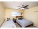 Inviting bedroom featuring two twin beds, a ceiling fan, and natural light at 2113 N 66Th St, Scottsdale, AZ 85257