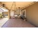 Inviting covered patio with tiled flooring, comfortable seating and decorative string lights at 2113 N 66Th St, Scottsdale, AZ 85257