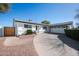 Charming single-story home featuring a well-manicured lawn and a spacious driveway leading to an attached two-car garage at 2113 N 66Th St, Scottsdale, AZ 85257