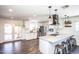 Bright and spacious kitchen featuring stainless steel appliances, white cabinets, and a large center island with bar seating at 2113 N 66Th St, Scottsdale, AZ 85257