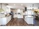 Modern kitchen with white cabinets, granite countertops, stainless steel appliances, and a center island for food preparation at 2113 N 66Th St, Scottsdale, AZ 85257