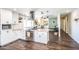 A well-lit kitchen featuring modern appliances, granite countertops, an island, and direct access to the dining and living area at 2113 N 66Th St, Scottsdale, AZ 85257