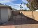 Small, fenced backyard with gravel and a partial view of a neighboring house at 2221 S Saratoga Dr, Mesa, AZ 85202