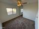 Bedroom with mirrored closet doors and ceiling fan at 2221 S Saratoga Dr, Mesa, AZ 85202