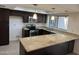 Modern kitchen featuring dark wood cabinets, granite countertops, and stainless steel appliances at 2221 S Saratoga Dr, Mesa, AZ 85202