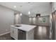 Modern kitchen with island, stainless steel appliances, and white cabinets at 2477 W Market Pl # 55, Chandler, AZ 85248