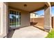 View of the outdoor covered patio with access to the backyard through a glass sliding door at 3129 W Fremont Rd, Phoenix, AZ 85041