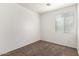 A clean bedroom with neutral carpet, white walls, and natural light from a window with window blinds at 3129 W Fremont Rd, Phoenix, AZ 85041