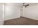 Spacious bedroom with carpet flooring, a ceiling fan, and natural light from a side window at 3129 W Fremont Rd, Phoenix, AZ 85041