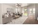 Bright living room featuring stylish furniture, a ceiling fan, and sliding doors to the backyard at 3129 W Fremont Rd, Phoenix, AZ 85041