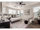 Stylishly decorated main bedroom with a ceiling fan, carpet, lots of natural light and modern décor at 3129 W Fremont Rd, Phoenix, AZ 85041