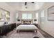 Spacious main bedroom featuring a modern ceiling fan, neutral carpet, and bright light from several windows at 3129 W Fremont Rd, Phoenix, AZ 85041