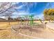 Community playground area with various climbing structures and a soft, sandy base at 3129 W Fremont Rd, Phoenix, AZ 85041