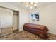 A bedroom with a twin bed, mirrored closet, and ceiling fan at 3432 N 86Th Ave, Phoenix, AZ 85037