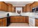 Kitchen featuring dark wood cabinets and granite countertops at 3432 N 86Th Ave, Phoenix, AZ 85037