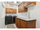 Laundry room with modern washer, dryer, and granite countertop at 3432 N 86Th Ave, Phoenix, AZ 85037