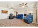 Spacious living room featuring two blue armchairs and a massage chair at 3432 N 86Th Ave, Phoenix, AZ 85037