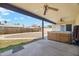 Covered patio with hot tub, ceiling fans, and view of backyard at 3432 N 86Th Ave, Phoenix, AZ 85037