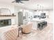 Modern kitchen with white cabinets, an island, and a fireplace at 356 Ancora W Dr, Litchfield Park, AZ 85340