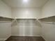 Large walk-in closet with double hanging rods at 38123 N Stallion St, San Tan Valley, AZ 85140