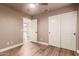 Well-lit bedroom with wood floors and double doors at 4213 E Stanford Ave, Gilbert, AZ 85234