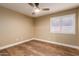 Bright bedroom with wood-look floors, a ceiling fan, and window shutters at 4213 E Stanford Ave, Gilbert, AZ 85234