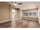 Bright bedroom featuring wood floors, plantation shutters, and a ceiling fan at 4213 E Stanford Ave, Gilbert, AZ 85234