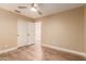 Bright bedroom with wood-look floors and double doors at 4213 E Stanford Ave, Gilbert, AZ 85234