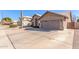 Tan house with a two-car garage and a wooden gate at 4213 E Stanford Ave, Gilbert, AZ 85234