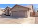 Tan house with a two-car garage and a wooden gate at 4213 E Stanford Ave, Gilbert, AZ 85234