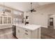 Island kitchen with white cabinets and quartz countertops at 4213 E Stanford Ave, Gilbert, AZ 85234