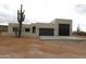 Contemporary exterior elevation showcasing a stucco finish and a black garage door at 431 W Rough Rider Rd, New River, AZ 85087