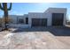 Contemporary home with a two-car garage and desert landscaping at 431 W Rough Rider Rd, New River, AZ 85087