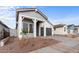 Charming single-story home with a gray exterior, complemented by a beautifully landscaped front yard at 4412 N 203Rd Dr, Buckeye, AZ 85396