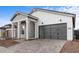 A modern single-story home featuring a gray-painted garage door and professionally paved driveway at 4412 N 203Rd Dr, Buckeye, AZ 85396