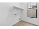 Bright laundry room featuring a window, shelving, outlets, and tile flooring at 4412 N 203Rd Dr, Buckeye, AZ 85396