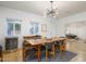 Bright dining room features a wood table, mid-century modern chairs, and wine cooler at 4841 E Amelia Ave, Phoenix, AZ 85018