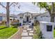 Updated mid-century modern home with a well-manicured lawn and walkway at 4841 E Amelia Ave, Phoenix, AZ 85018