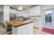 Modern kitchen with white cabinets, butcher block island, and stainless steel appliances at 4841 E Amelia Ave, Phoenix, AZ 85018